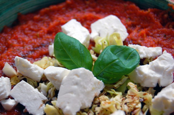 томатный соус со свежими листьями базилика и козьим сыром в керамике
  - Фото, изображение