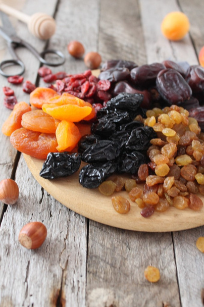 Dried apricots, dates, raisins, vintage wooden background, selective focus - Photo, Image