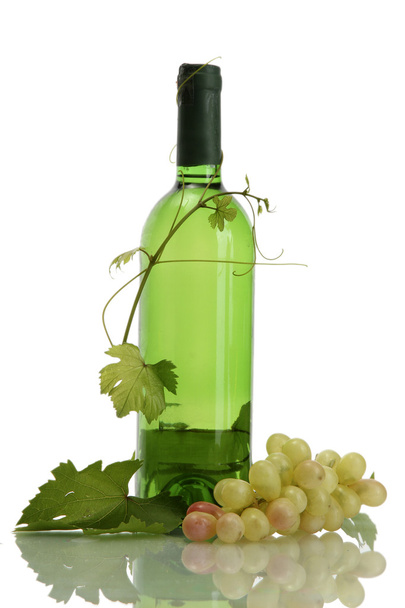 Bottle of wine and ripe grapes isolated on white - Photo, image