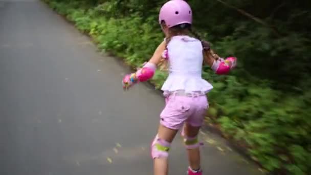 Girl in helmet riding on roller skates  - Кадры, видео