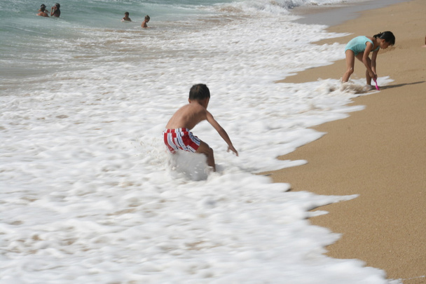Children playing in he sea - Photo, image