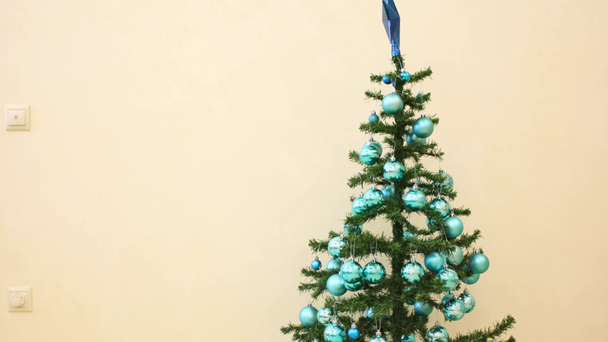 Blue decorations appear on Christmas tree - Footage, Video