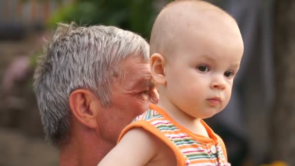 footage grandfather holds grandson on hands in the open air, close-up. - Footage, Video