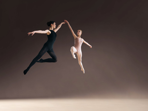 Two ballet dancers jumping high, in air. - Photo, Image