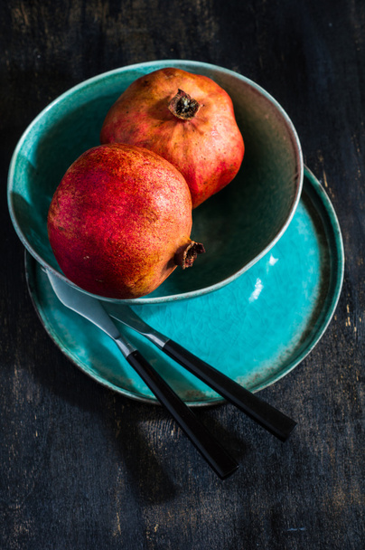 Fresh pomegranate on vintage plate - Fotó, kép