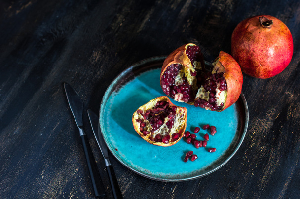 Fresh pomegranate on vintage plate - Photo, Image