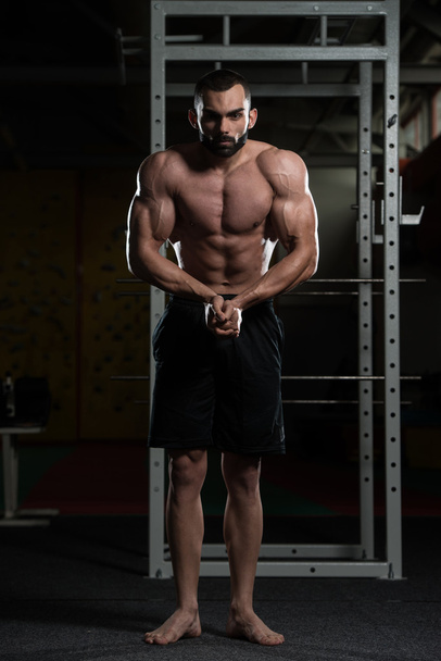 Handsome Body Builder Making Most Muscular Pose - Φωτογραφία, εικόνα