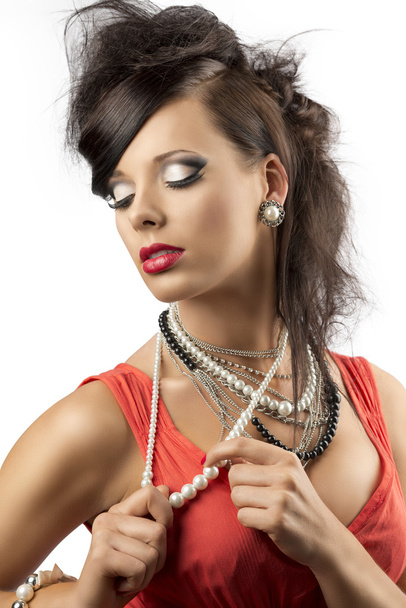 Portrait of fashion brunette that touches one necklace - Foto, imagen