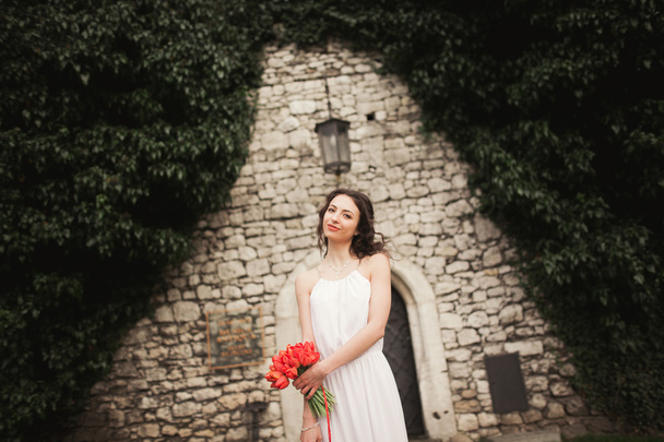 Bride. Beautiful young woman in the park with bouquet on a warm summer day. - Foto, Imagen