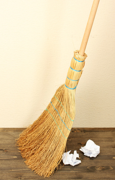 Broom and papers on floor in room - Фото, изображение