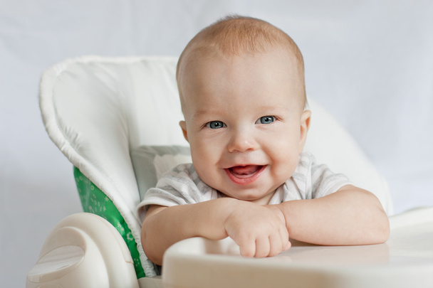 portrait of a happy baby in a highchair - Foto, imagen