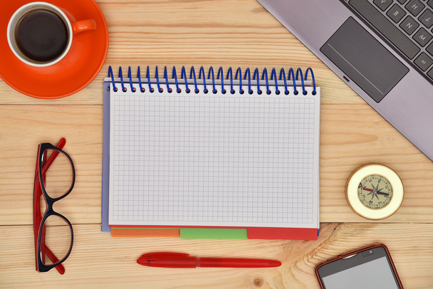 Blank notebook and material office desktop on wooden desk, top view. - Foto, Imagem