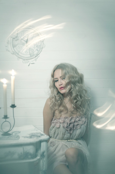 Pretty blonde woman in a white interior - Fotó, kép