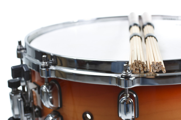 Unplugged drumsticks resting on a snare drum - Photo, Image