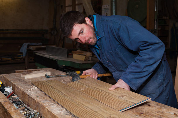 Carpenter working on a Wooden Boards in his Workshop - Foto, Imagen