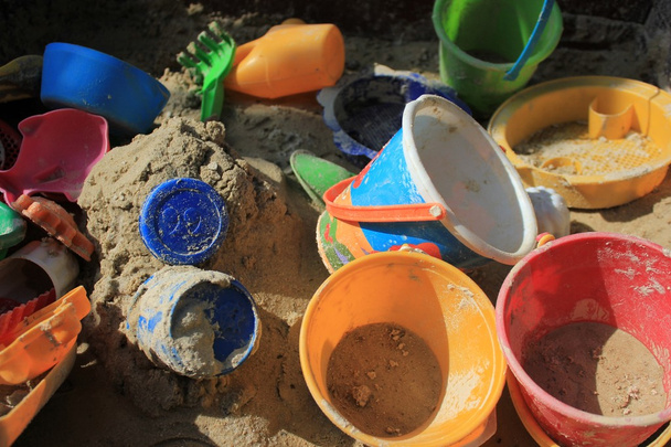 Gaily coloured toys in a sandbox - Photo, Image