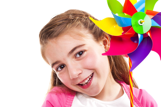 Happy girl holding a toy windmill - Φωτογραφία, εικόνα