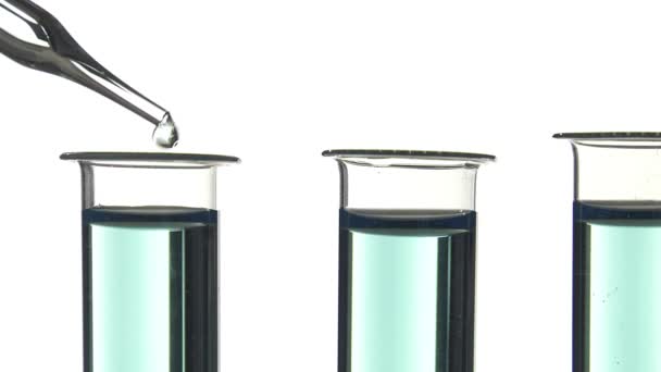 Test tube filled with blue liquid, pouring a drop of water - Footage, Video