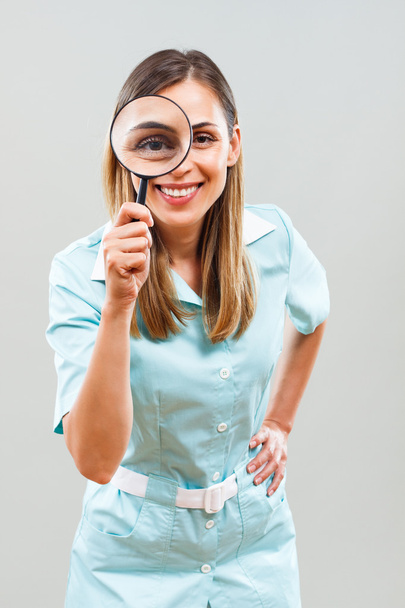 nurse with magnifying glass. - Фото, зображення