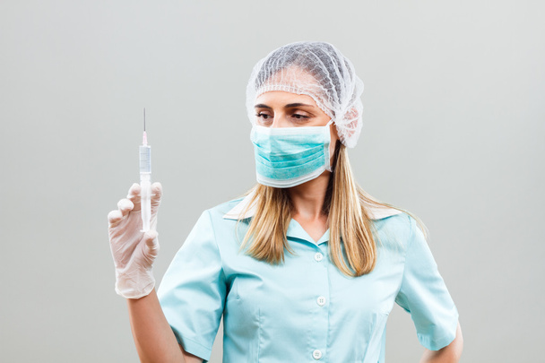 beautiful female doctor holding injection  - Фото, изображение