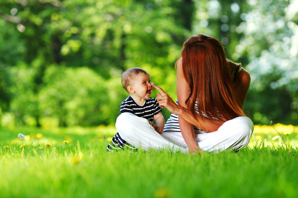 Mother and daughter on the green grass - Foto, immagini