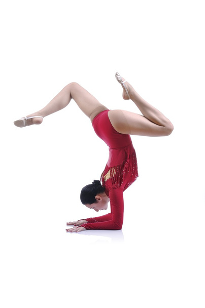 Beautiful artistic female gymnast working out, performing art gymnastics element - Fotoğraf, Görsel