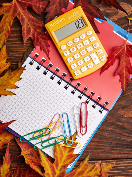 Notebook, calculator and autumn leaves - Photo, Image