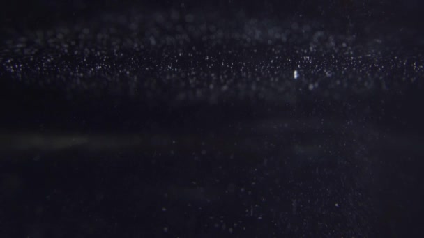 Bubbles reaching surface of water. Galaxy concept - Footage, Video