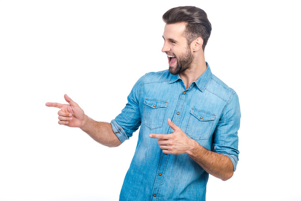 man in jeans shirt pointing away - Photo, image