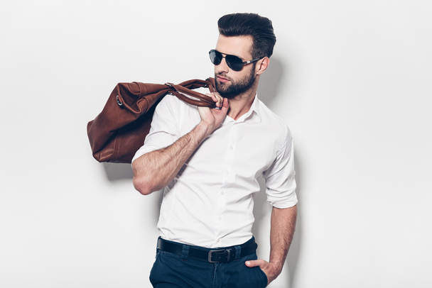 man in white shirt carrying leather bag - Photo, image