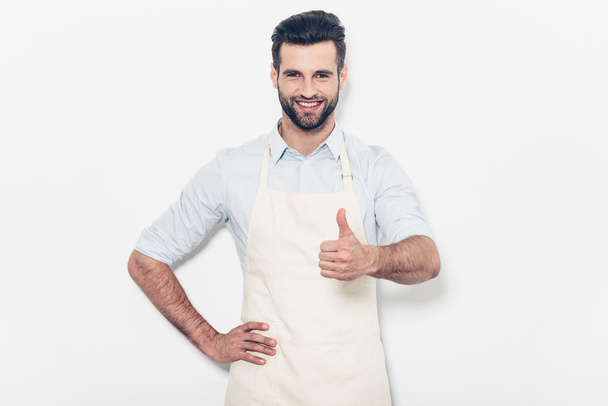 man  in apron show sign good thumb up - 写真・画像
