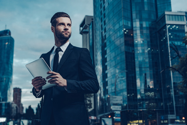 young man in full suit holding digital tablet - 写真・画像