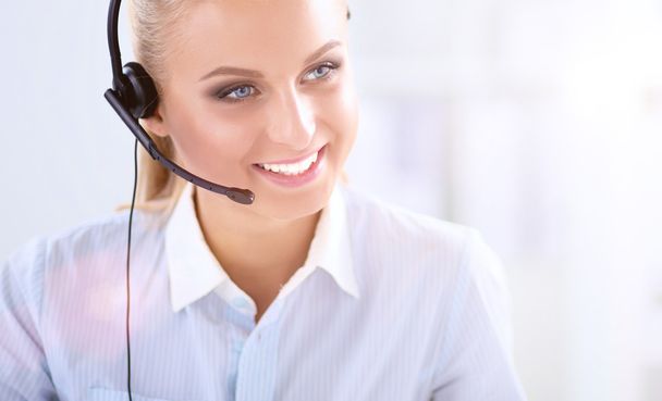 Close-up portrait of a customer service agent sitting at office - Foto, imagen