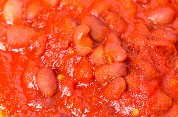 Cooked red beans in sauce closeup. - Фото, изображение