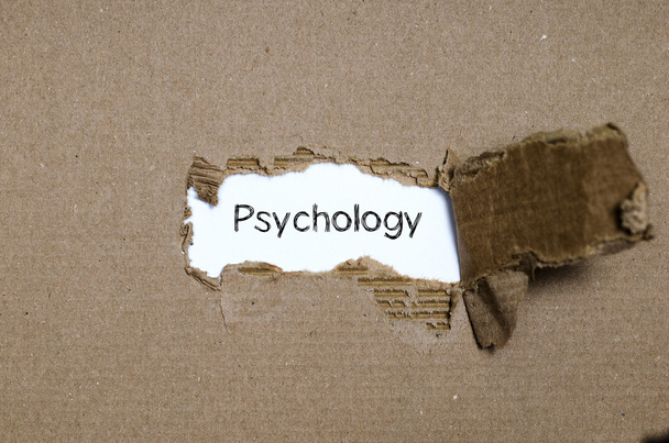 Słowo Psychologia pojawiające się za rozdarty papier. - Zdjęcie, obraz