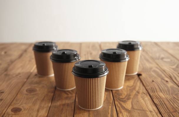 Five carton paper cups with black caps - Foto, immagini