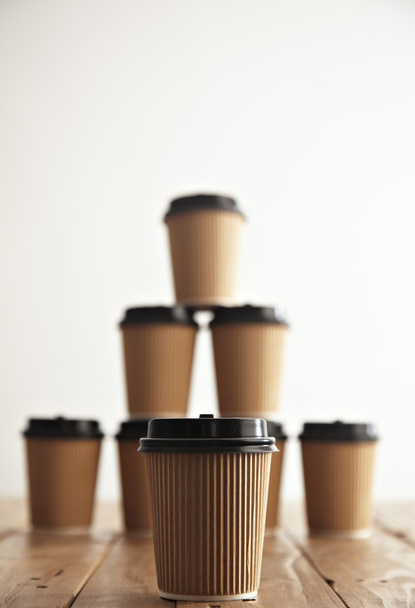 paper cups with black caps in pyramid  - 写真・画像