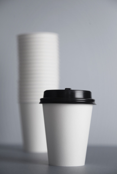 white paper cup with black cap - Fotoğraf, Görsel