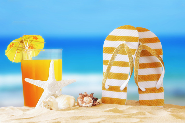 tropical sandy beach, fruit cocktail, sea shells and flip flops - Photo, Image