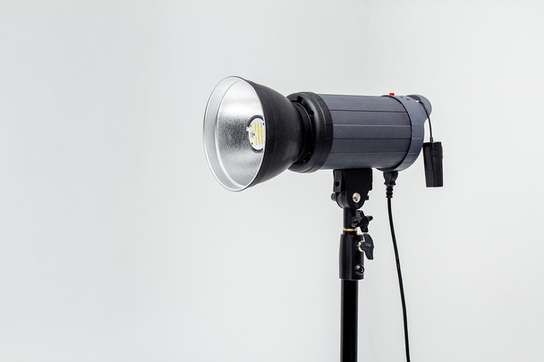 Studio flash impulse reflector on white - Photo, Image