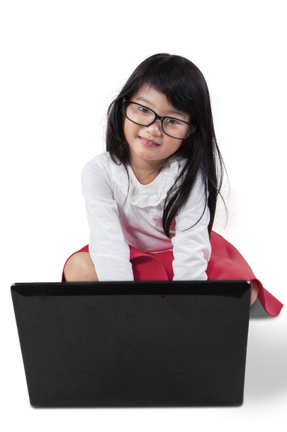 Attractive little girl with notebook computer - Фото, изображение