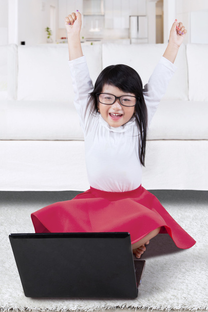 Happy girl raise hands with laptop at home - Valokuva, kuva