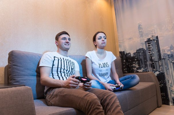 Vue latérale de couple accro jouant à des jeux vidéo
 - Photo, image