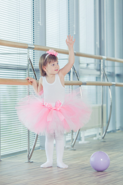 Adorable child dancing classical ballet in studio. - Zdjęcie, obraz