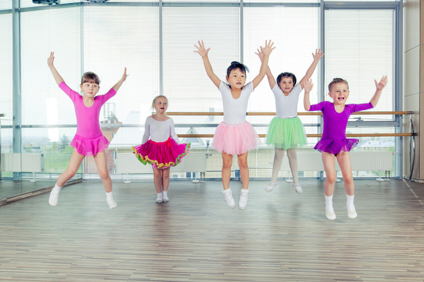 happy children dancing on in hall, healthy life, kids togetherness and happiness concept - Fotó, kép