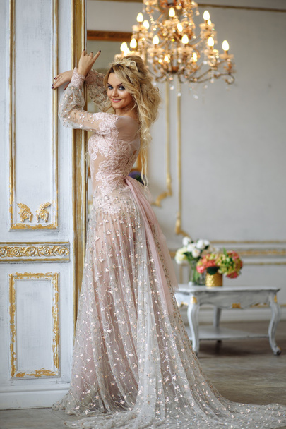 Gorgeous young woman with perfect makeup and hair style in luxury dress in interior - Foto, Imagem