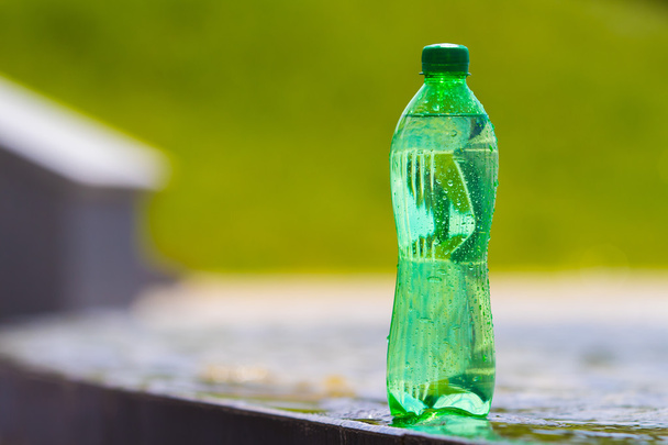 green bottle with water on blurred background - Photo, Image