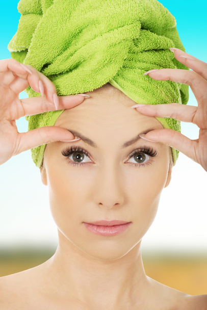 Woman checking wrinkles on her forehead. - Zdjęcie, obraz