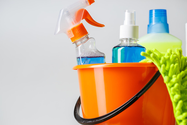 Bucket with cleaning items on light background - Photo, Image