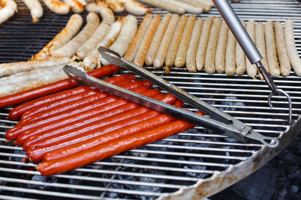 Street fast food, grilled sausages at bbq - Photo, Image